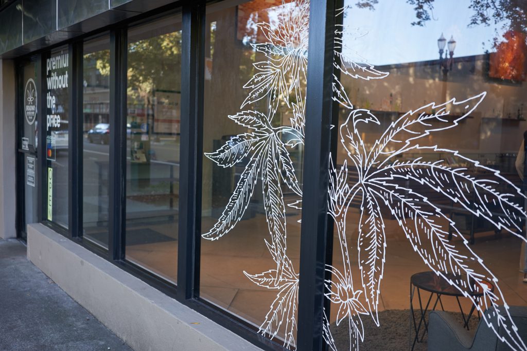 dispensary storefront with weed leaves on glass