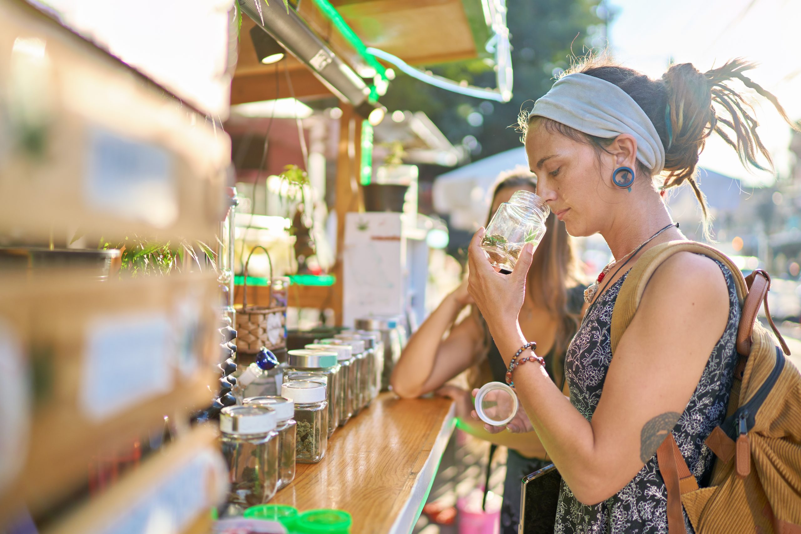 two female tourists shopping for marijuana at legal cannabis shop in pattaya thailand and smelling product